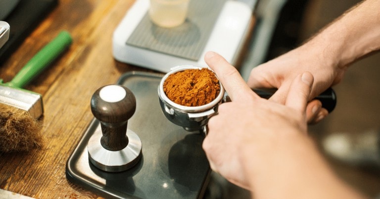 barista using an espresso tamper