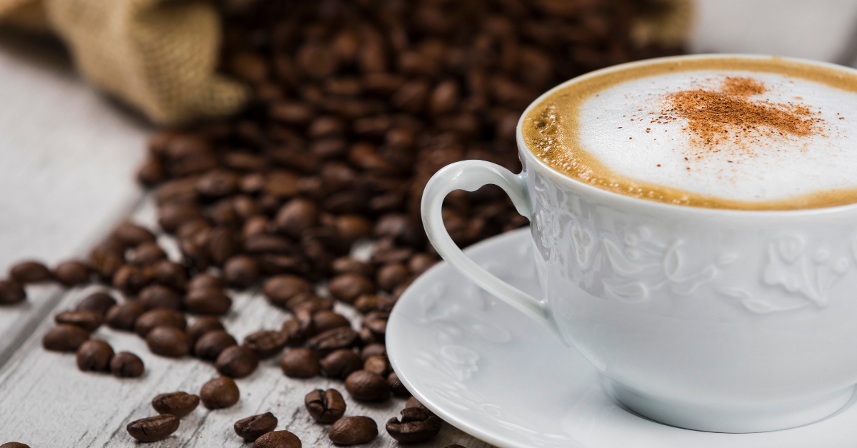 cappuccino in a cup and coffee beans