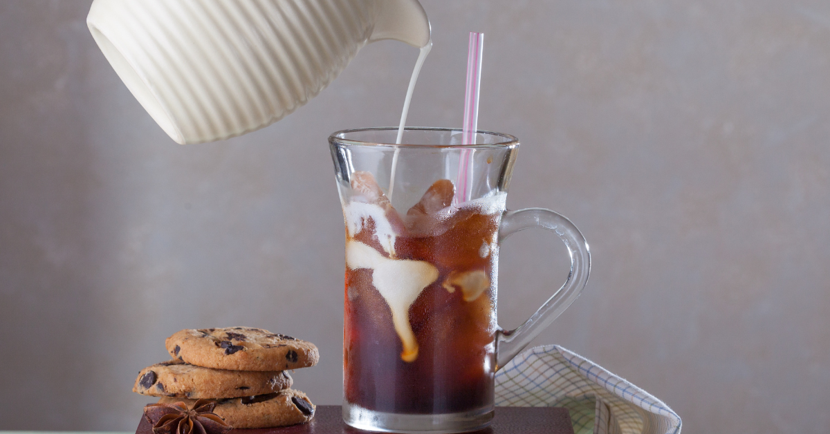 pouring milk in iced coffee with nespresso