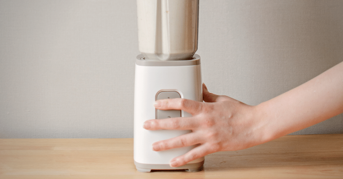 a person blending milk in a blender