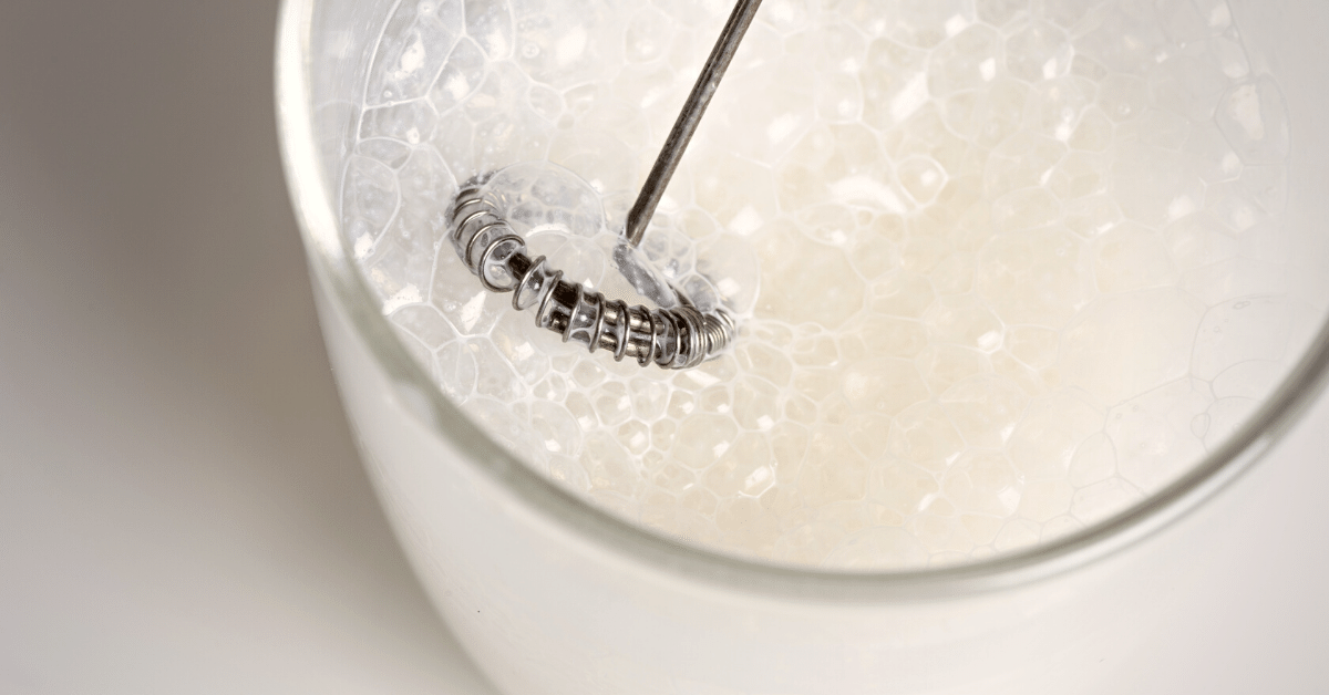 frothing milk with hand held frother