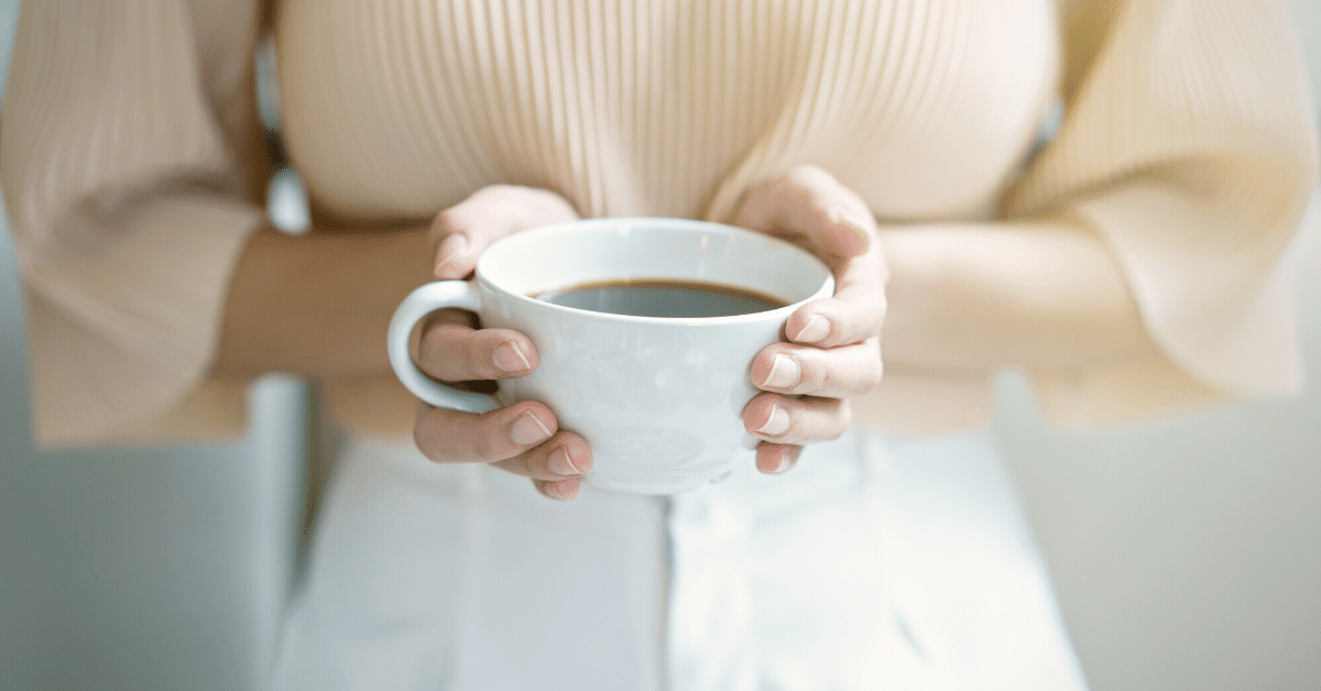 woman holding cup of coffee