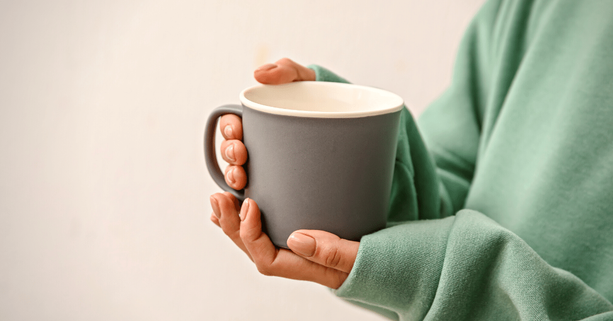 woman holding cup of coffee