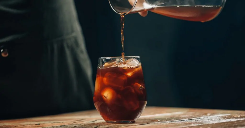 cold brew coffee being poured into glass