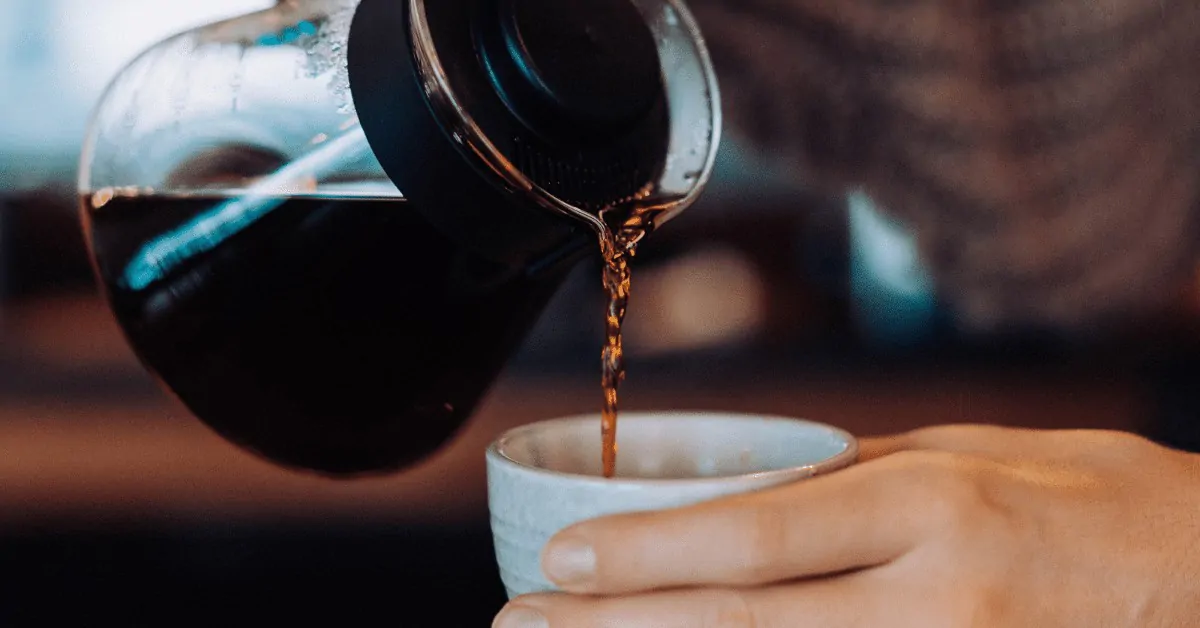 coffee being poured from a carafe into a cup