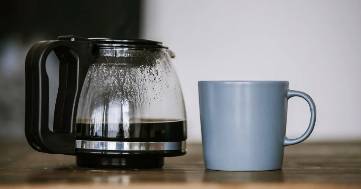 coffee maker carafe next to a mug