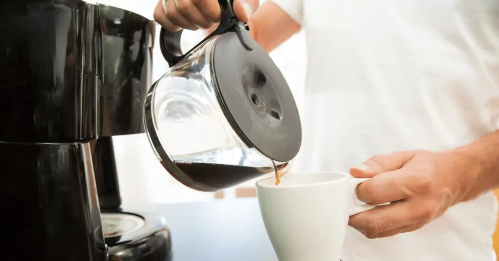 man pouring coffee into a mug