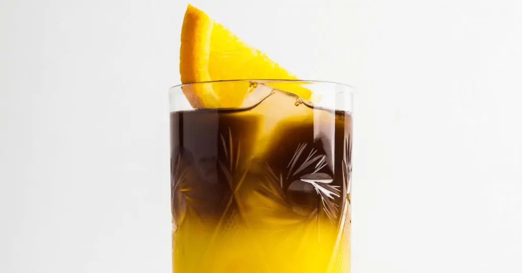 coffee and orange juice with a slice of orange on top