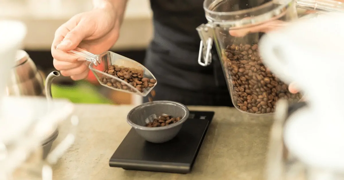 coffee scale being used to measure coffee beans