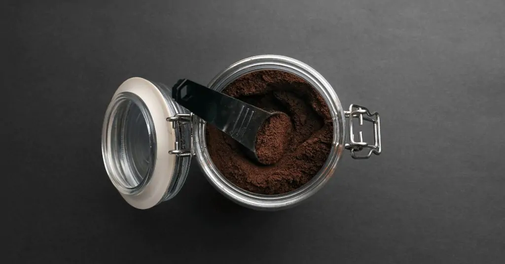 ground coffee in a glass coffee container