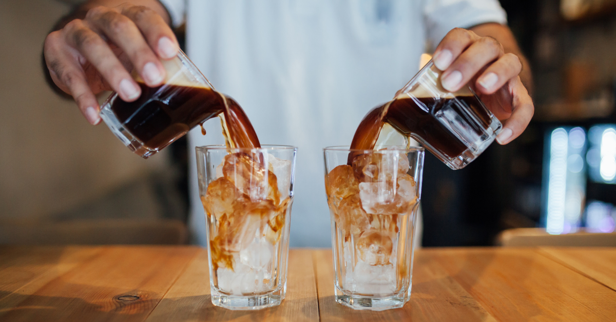 a person making iced coffee