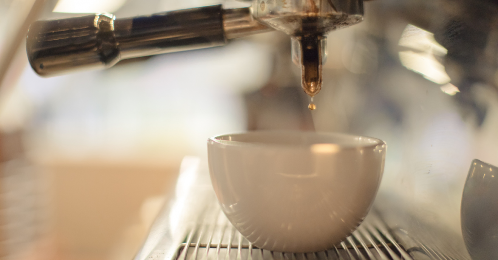 espresso machine pouring coffee into a cup