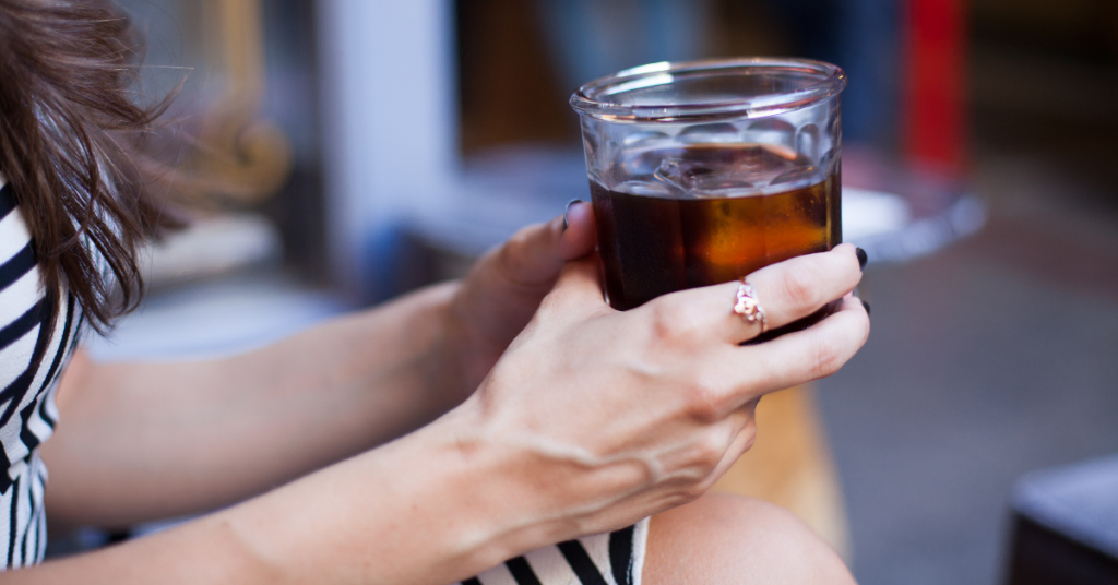 woman holding cold brew coffee