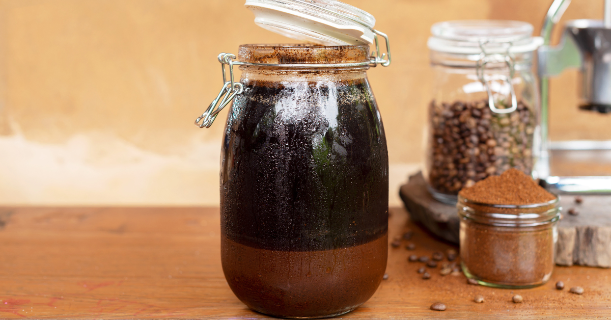 ground coffee soaked in cold water in a jar
