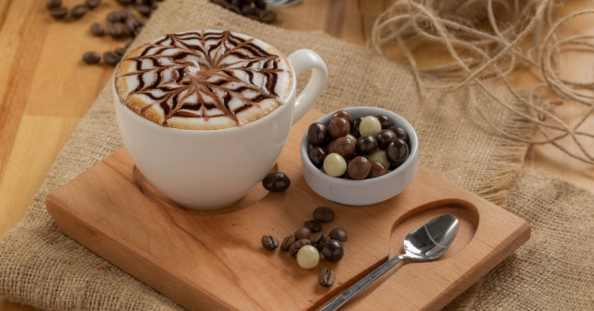mocha coffee and chocolate candy on wooden plate