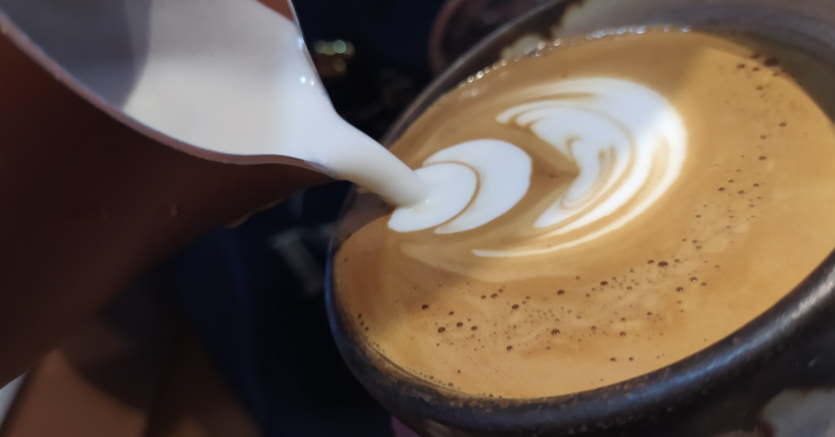 pouring milk in cappuccino