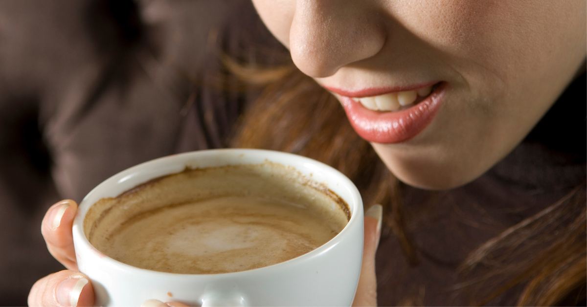 woman drinking cappuccino
