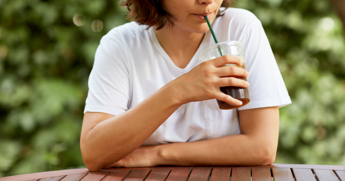woman drinking iced coffee