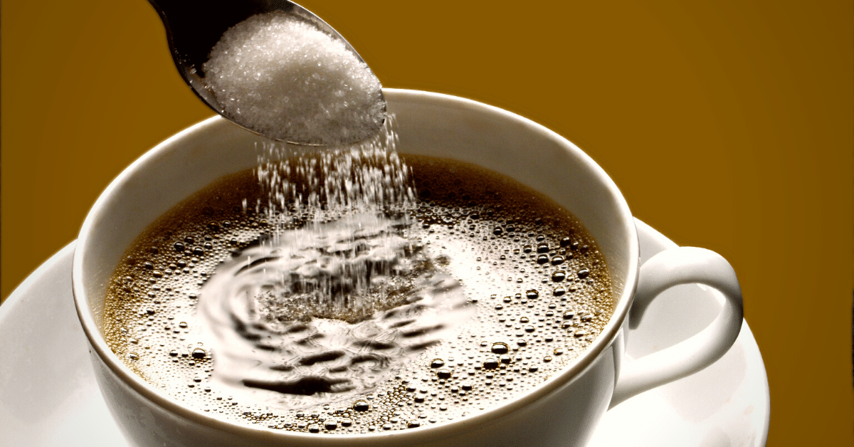 pouring sugar in a coffee