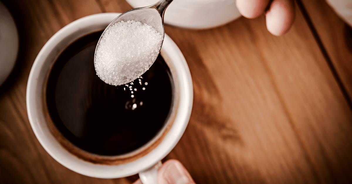 adding sugar to coffee