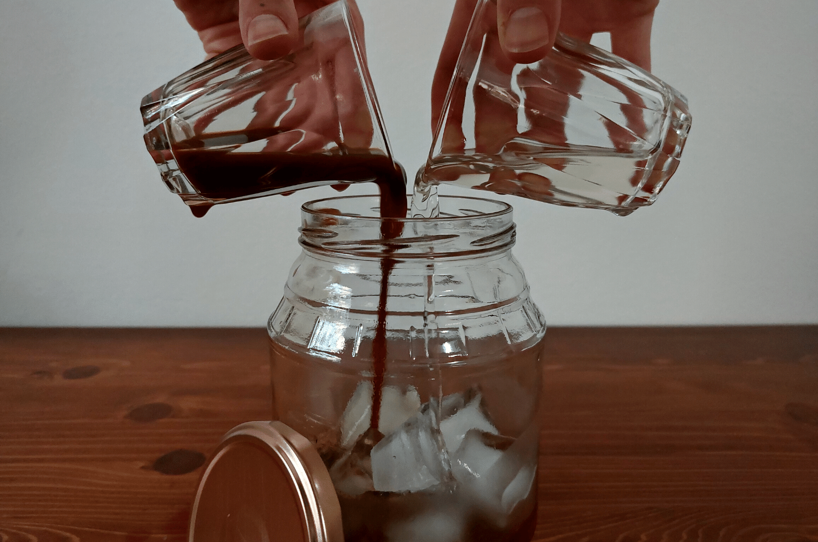 pouring espresso and sugar syrup in jar