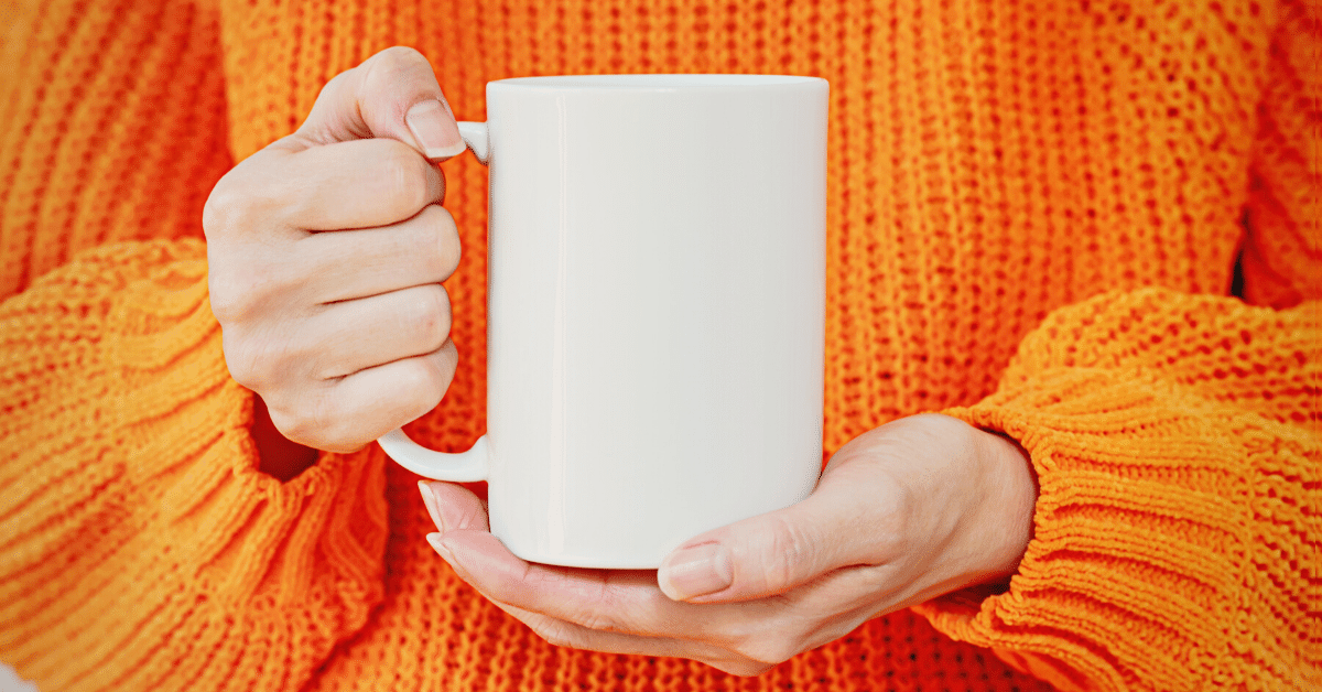 woman holding ceramic mug