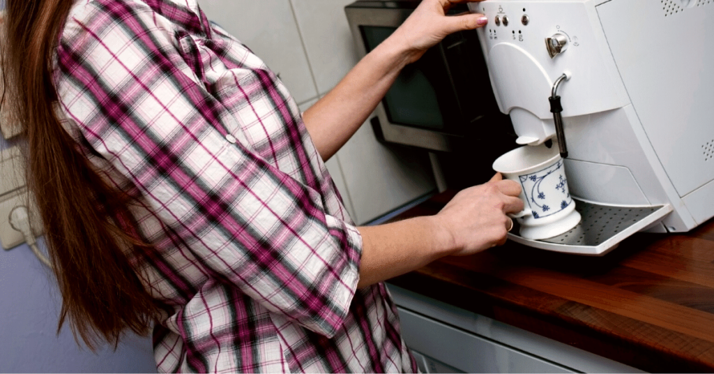 woman using coffee maker