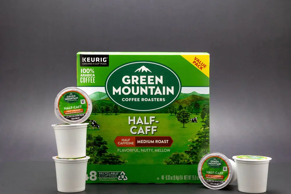 A box of Green Mountain Coffee Roasters Half Caffeine Medium Roast Coffee K-Cups Isolated on a black background